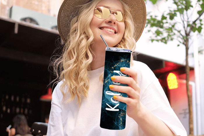 girl drinking from a personalized tumbler