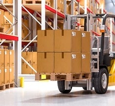forklift carrying a pallet of boxes